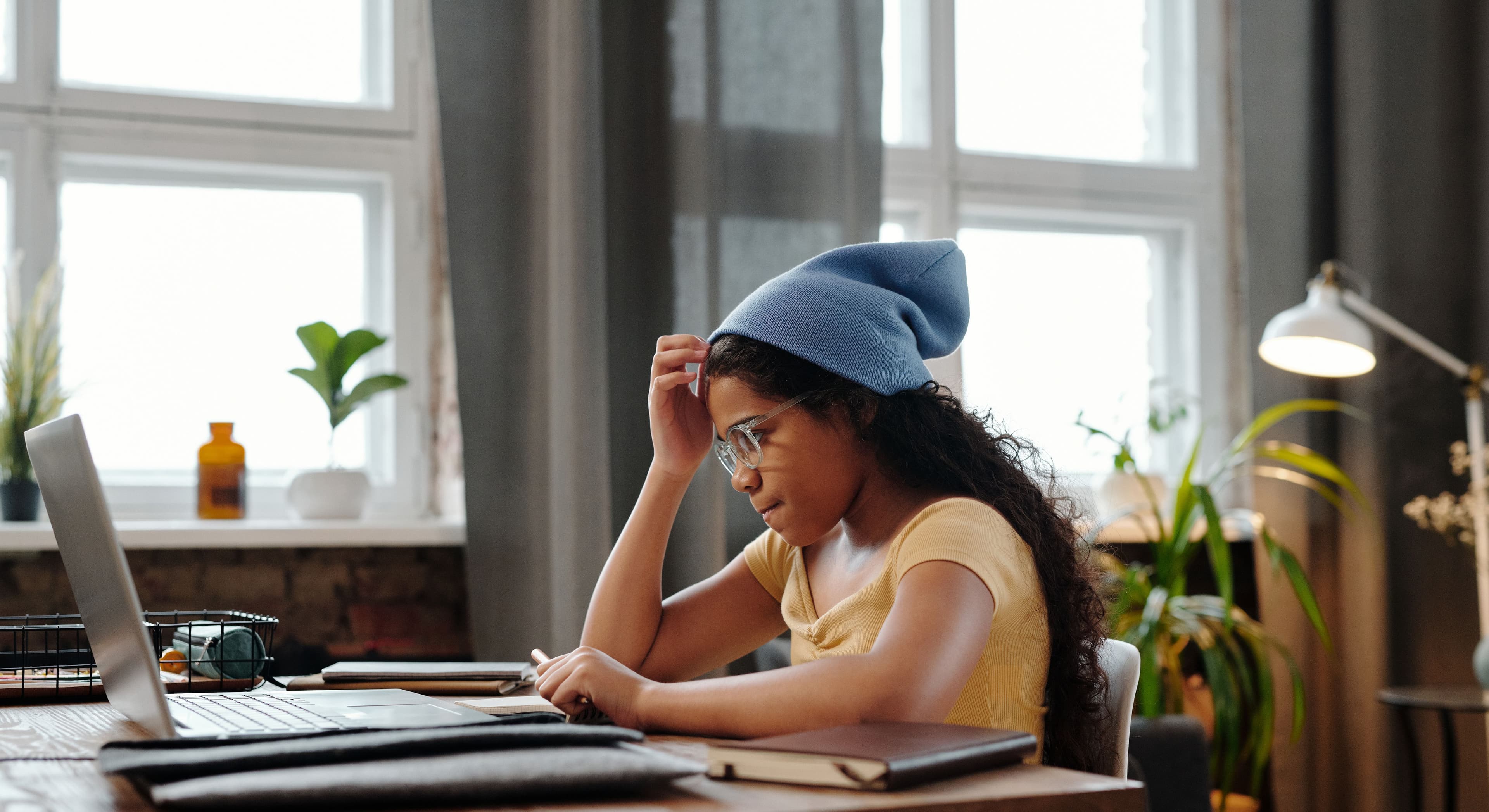 A student working through course material on a laptop at home