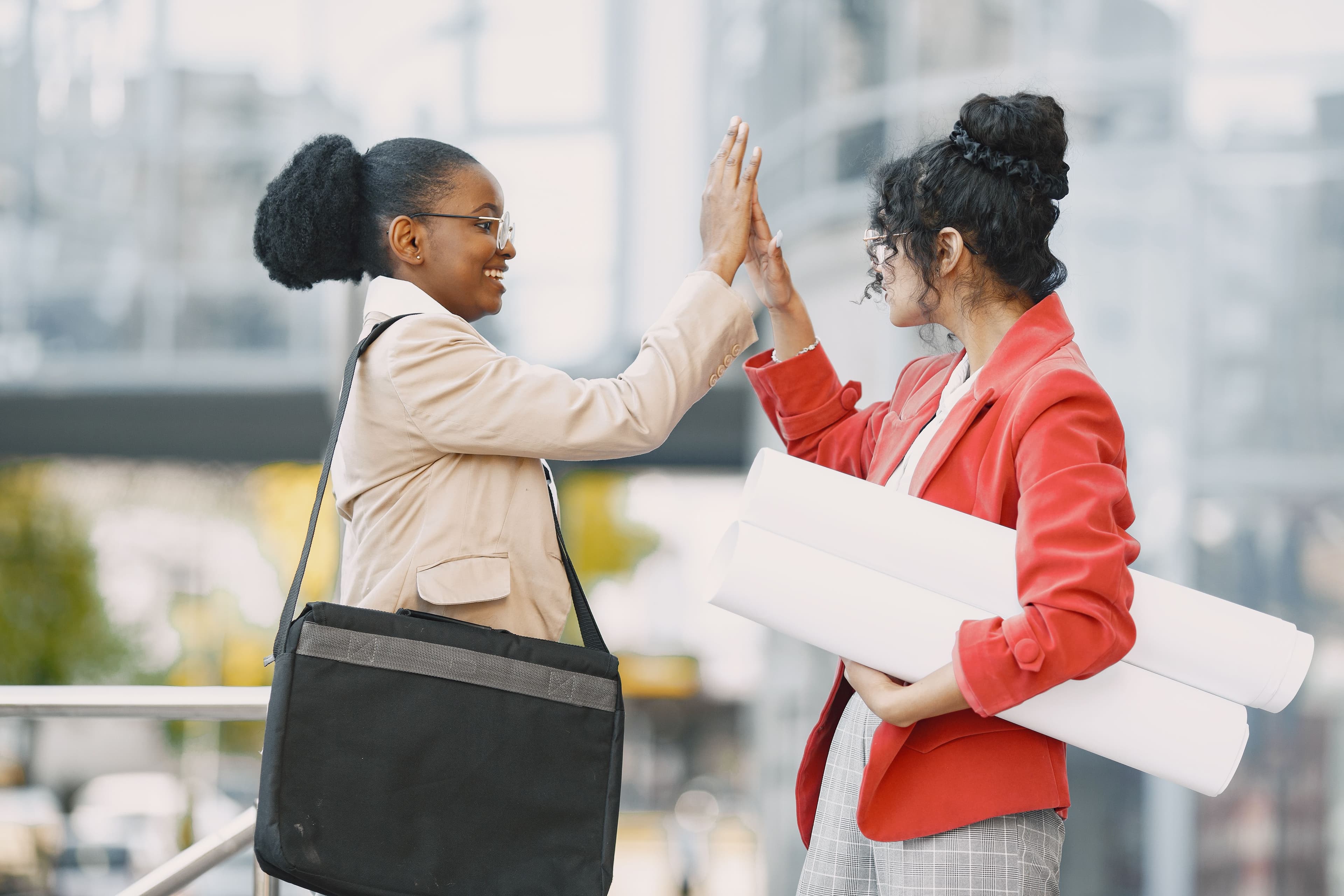 Two colleagues celebrating a milestone with a high five