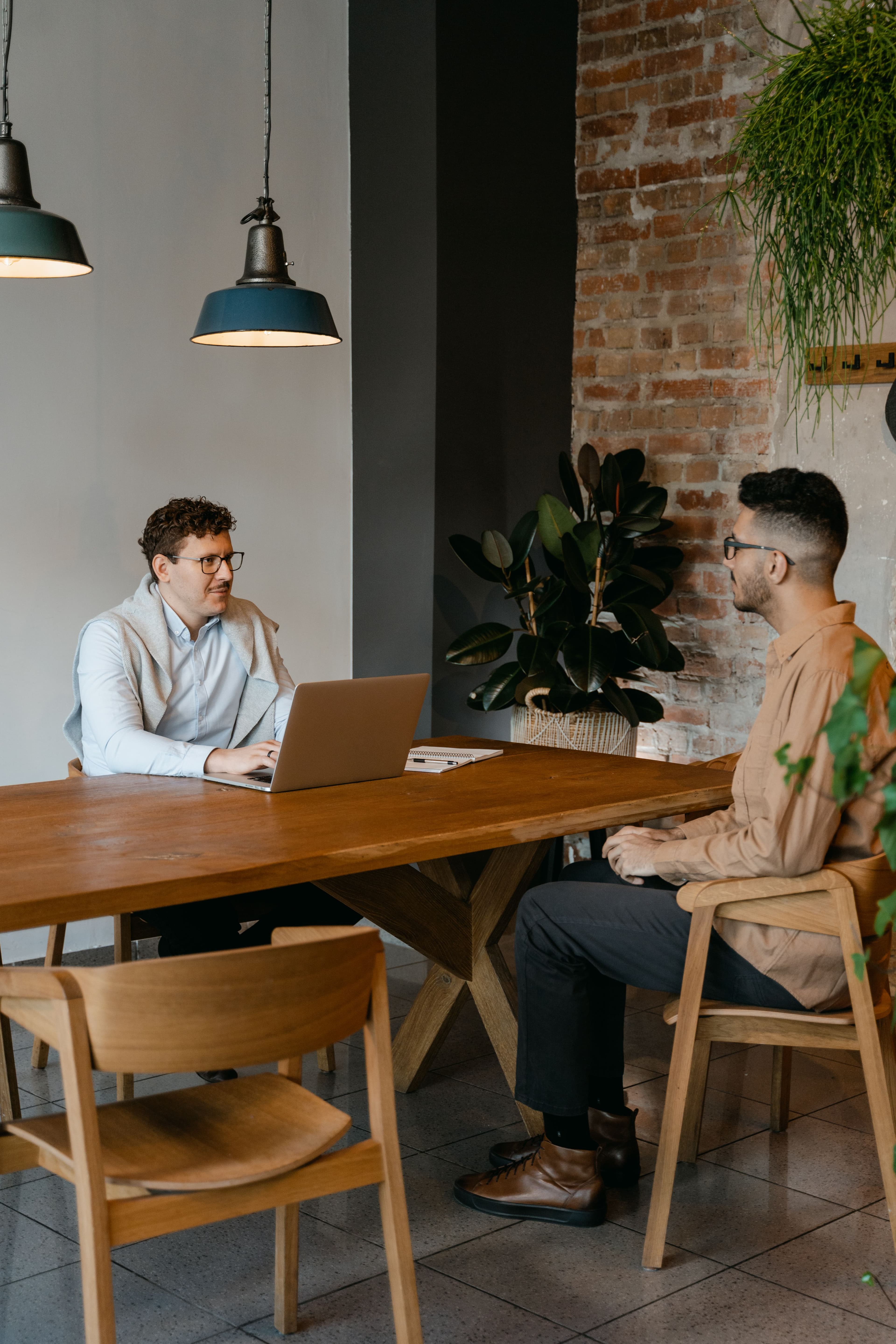 Two colleagues in discussion at a desk