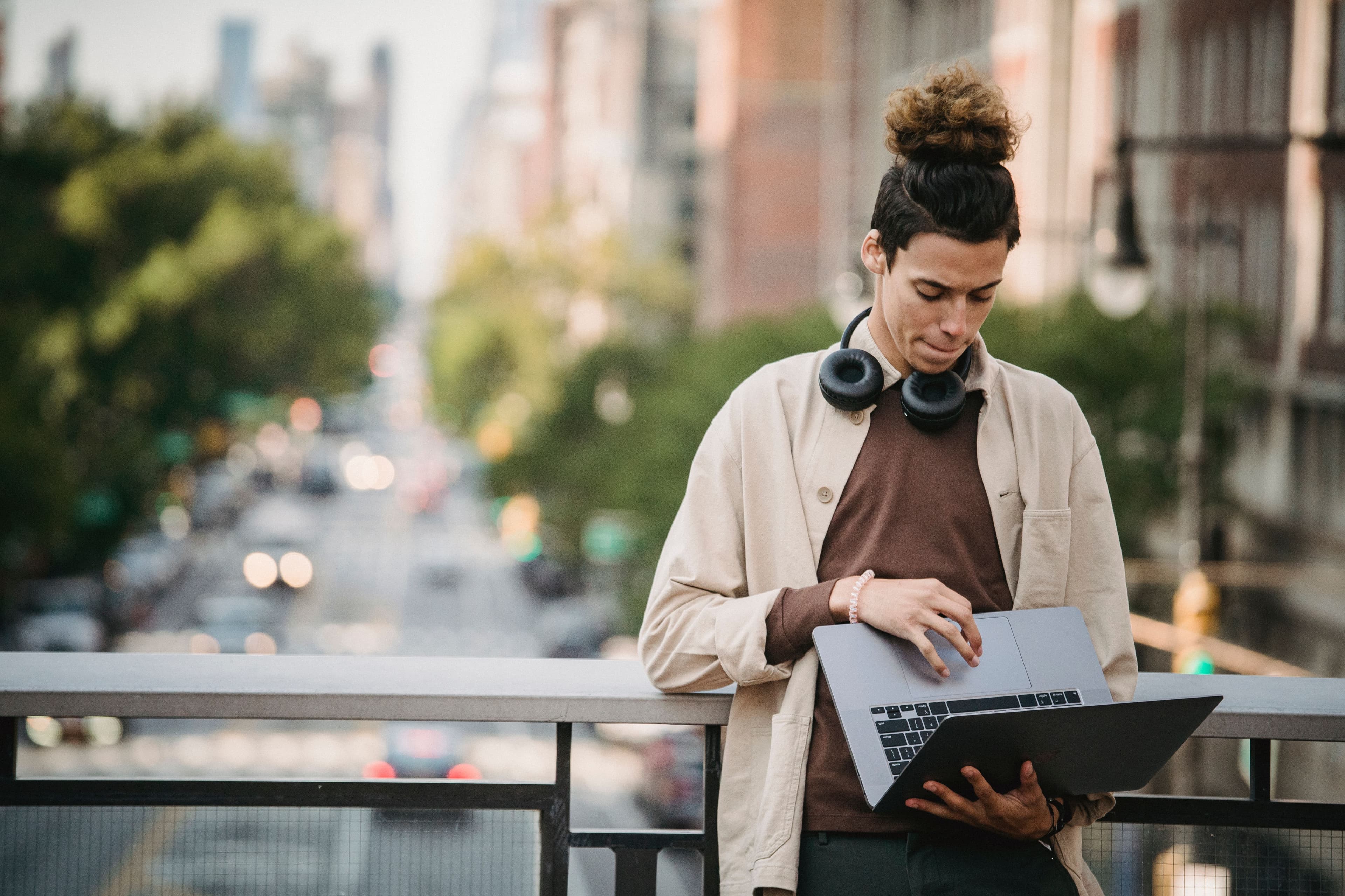 A person reviewing their laptop while working outdoors