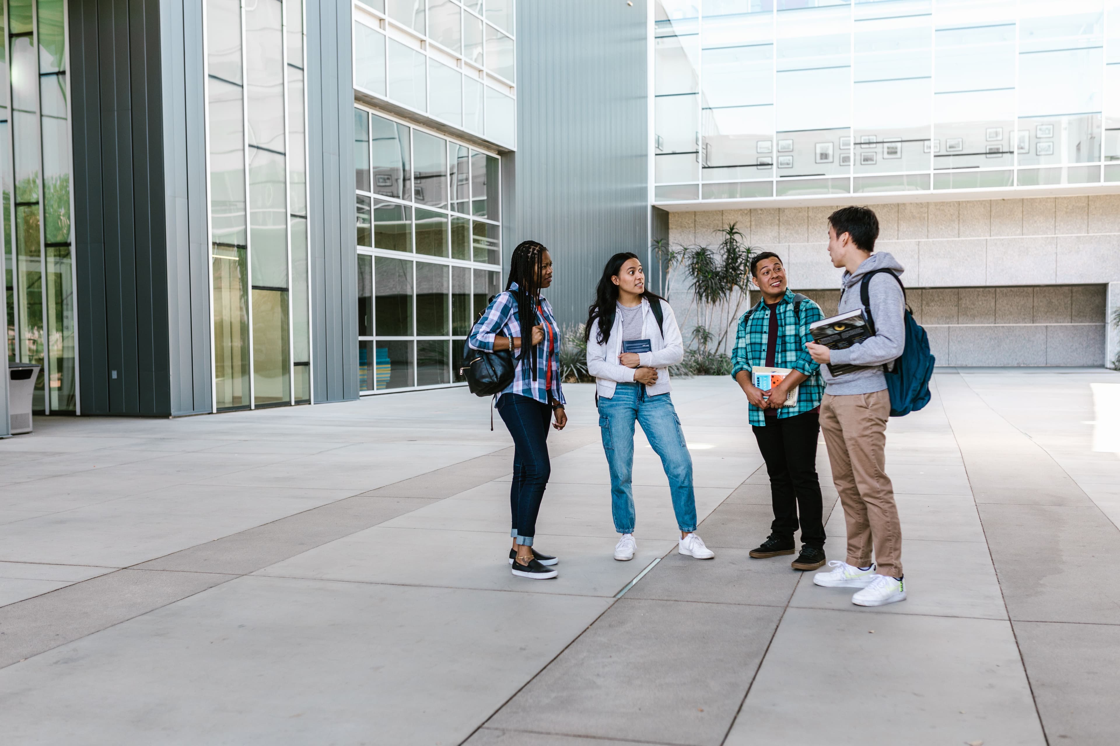 A group of students talking together outside an exam venue